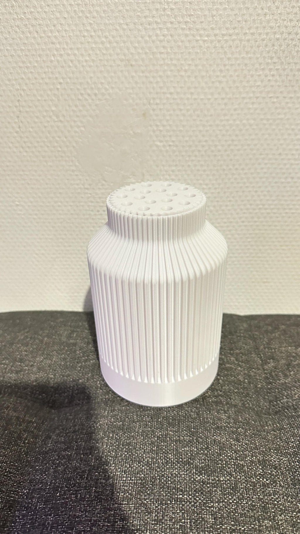 Vase bouteille cannelé blanc vu sans fleurs, avec son support de tiges intégré