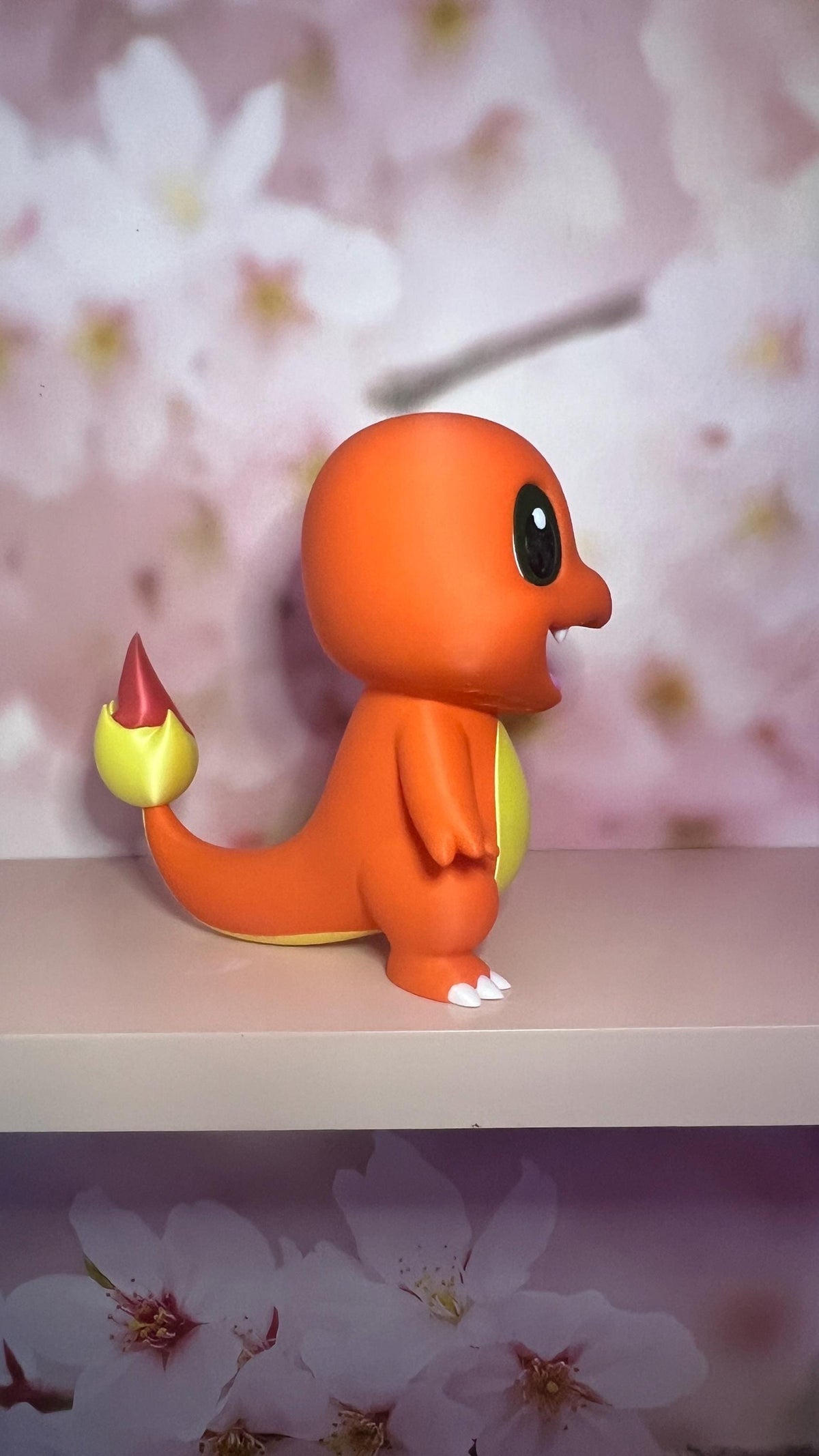 Figurine petit dragon orange style chibi, vue de trois quarts