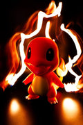 Figurine petit dragon orange style chibi, avec effet de flammes
